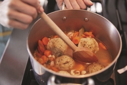 cooking matzah ball soup for passover dinner